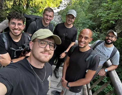 The Tapped team on a wooden bridge during a hike
