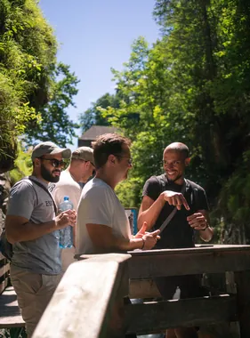 Tapped teammates talking on a wooden bridge in the forest