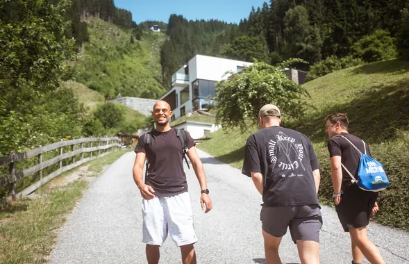 Tapped teammates hiking a mountain path